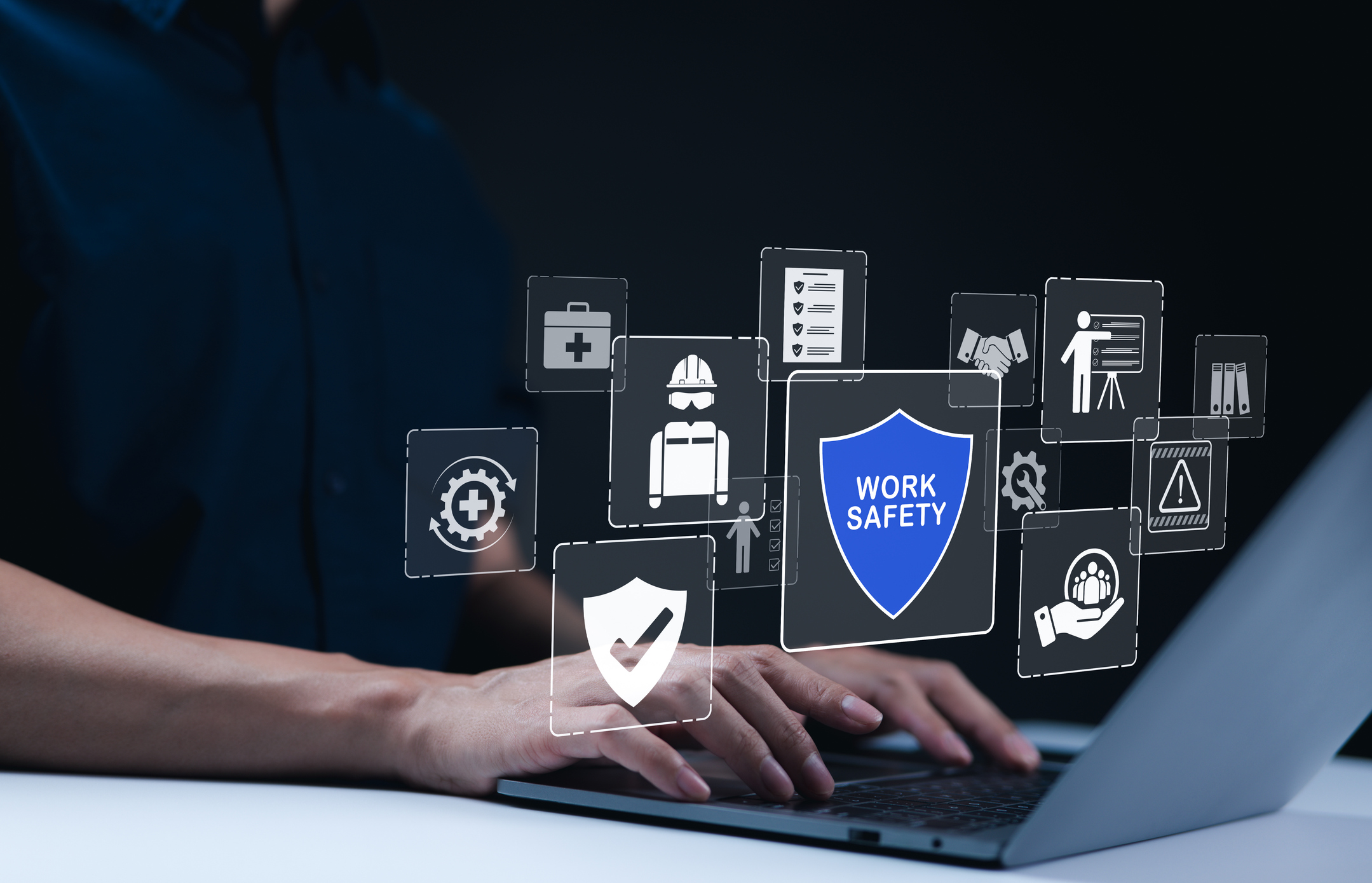 Work safety and compliance concepts. Businessman typing on laptop with virtual icons representing work safety, compliance, and security, workplace safety, and regulatory adherence. Safety first