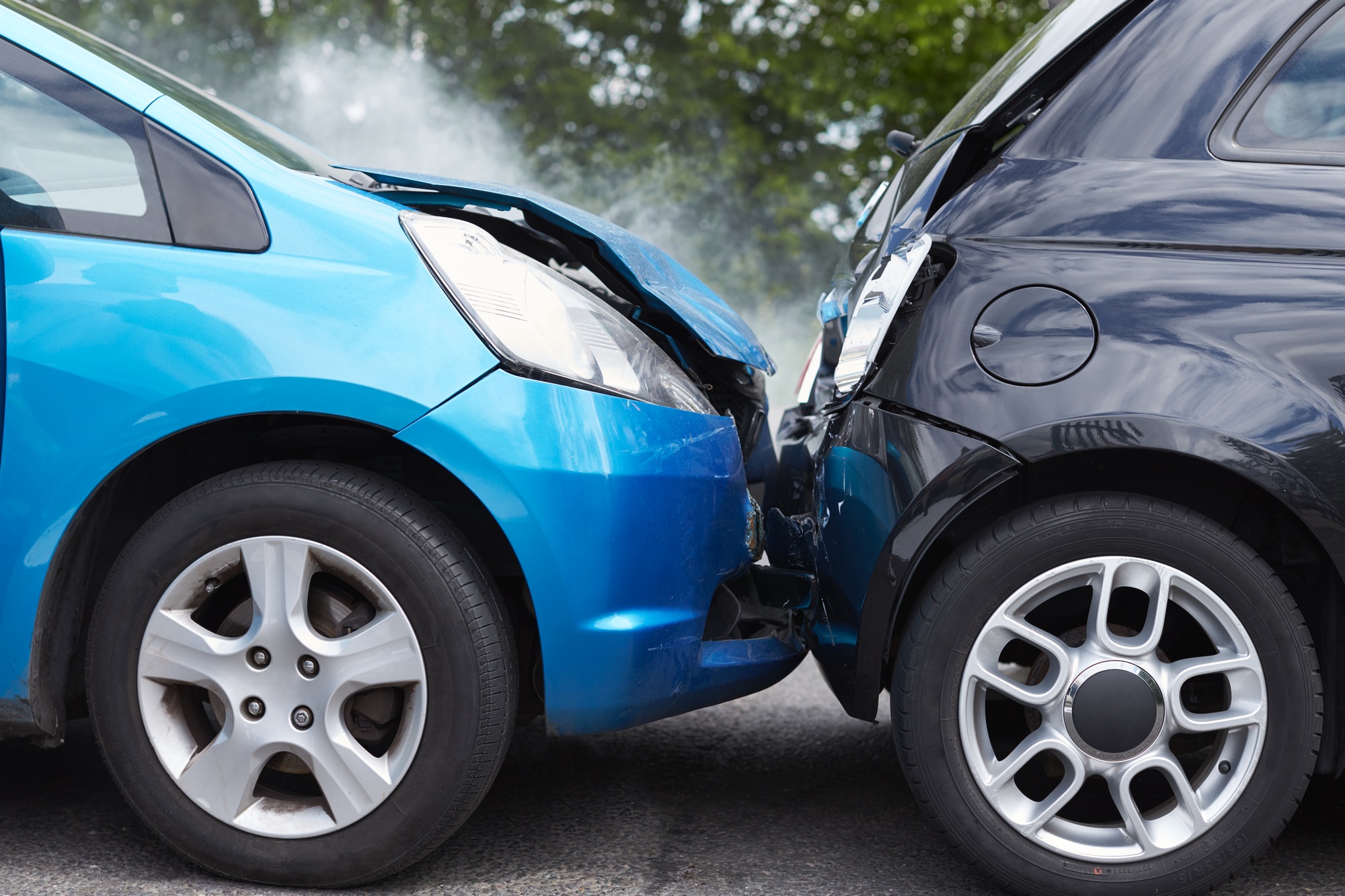 close up of two cars damaged in road traffic accident
